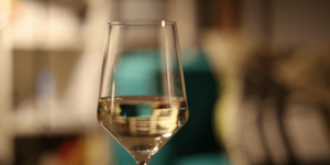 Wine glass holding clear sake inside.