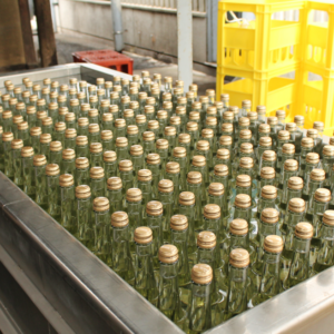 Many bottles of sake sitting in a tank, cooling down after a HIire treatment.