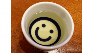 A small "ochoko" cup holding some squid-infused sake