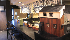 A retro cash register decorated like an old sake brewery add an artistic touch